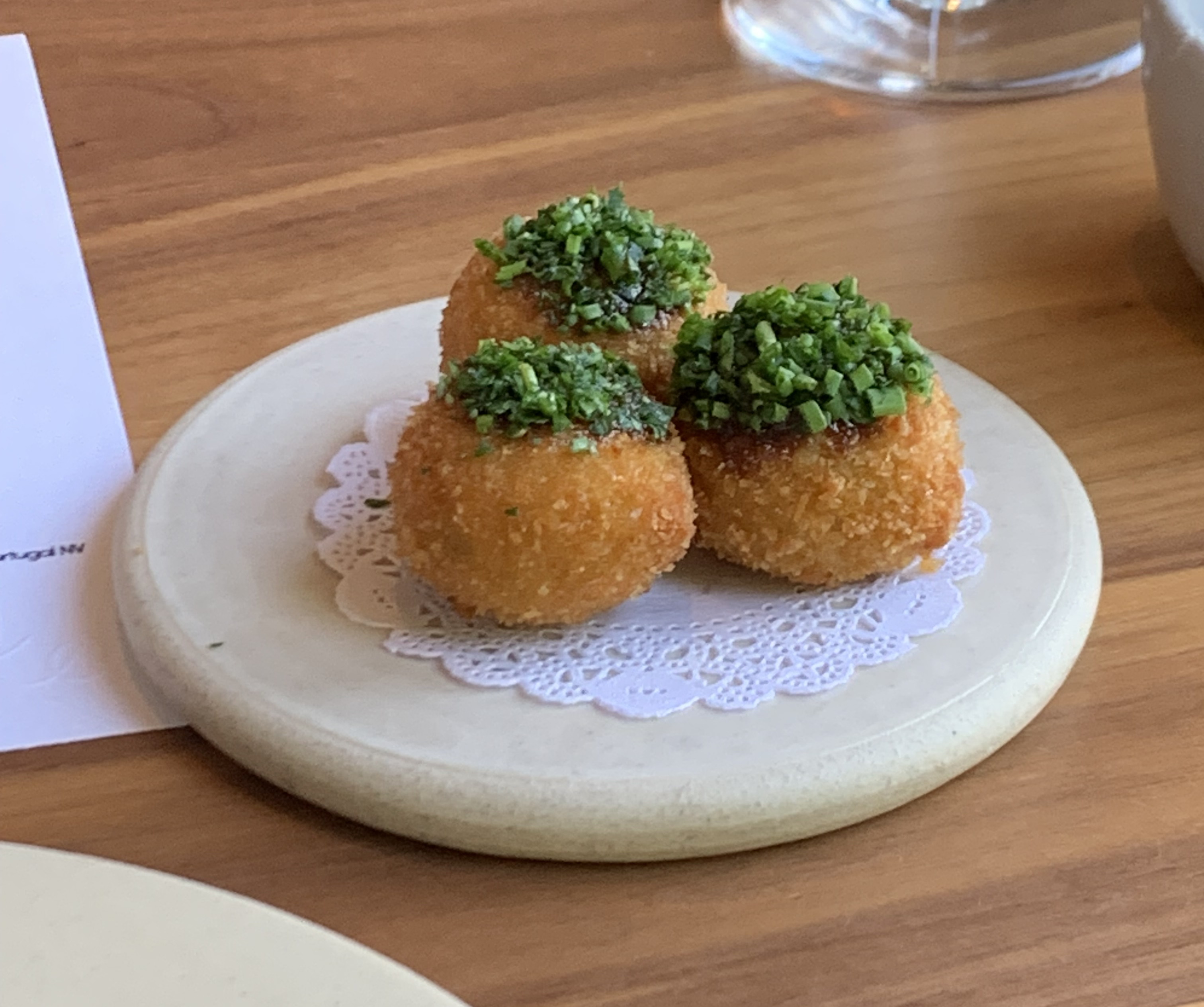 Three deep-fried balls, with lots of parsley stuck to the top