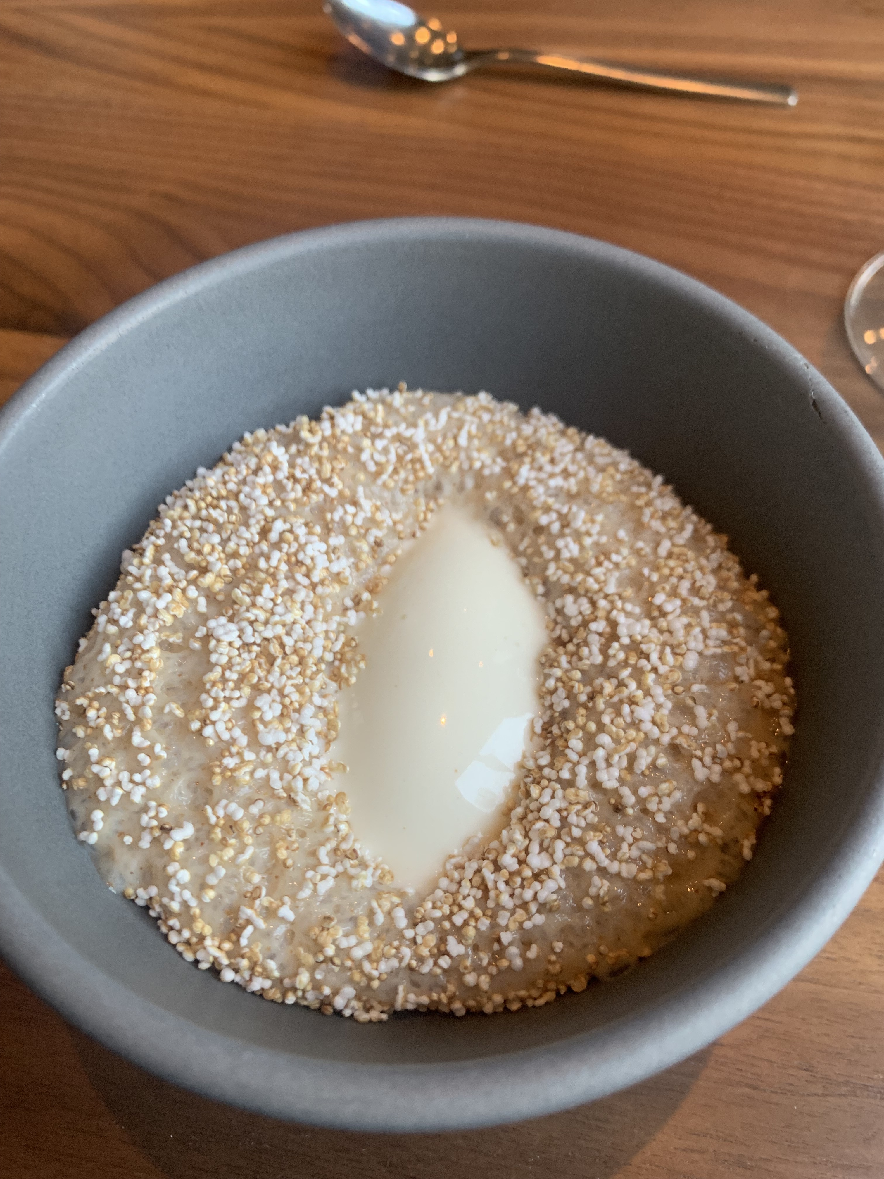 Light-brown pudding studded with toasted buckwheat grains. In the very center, like a cat's pupil, is an oval of ice cream.