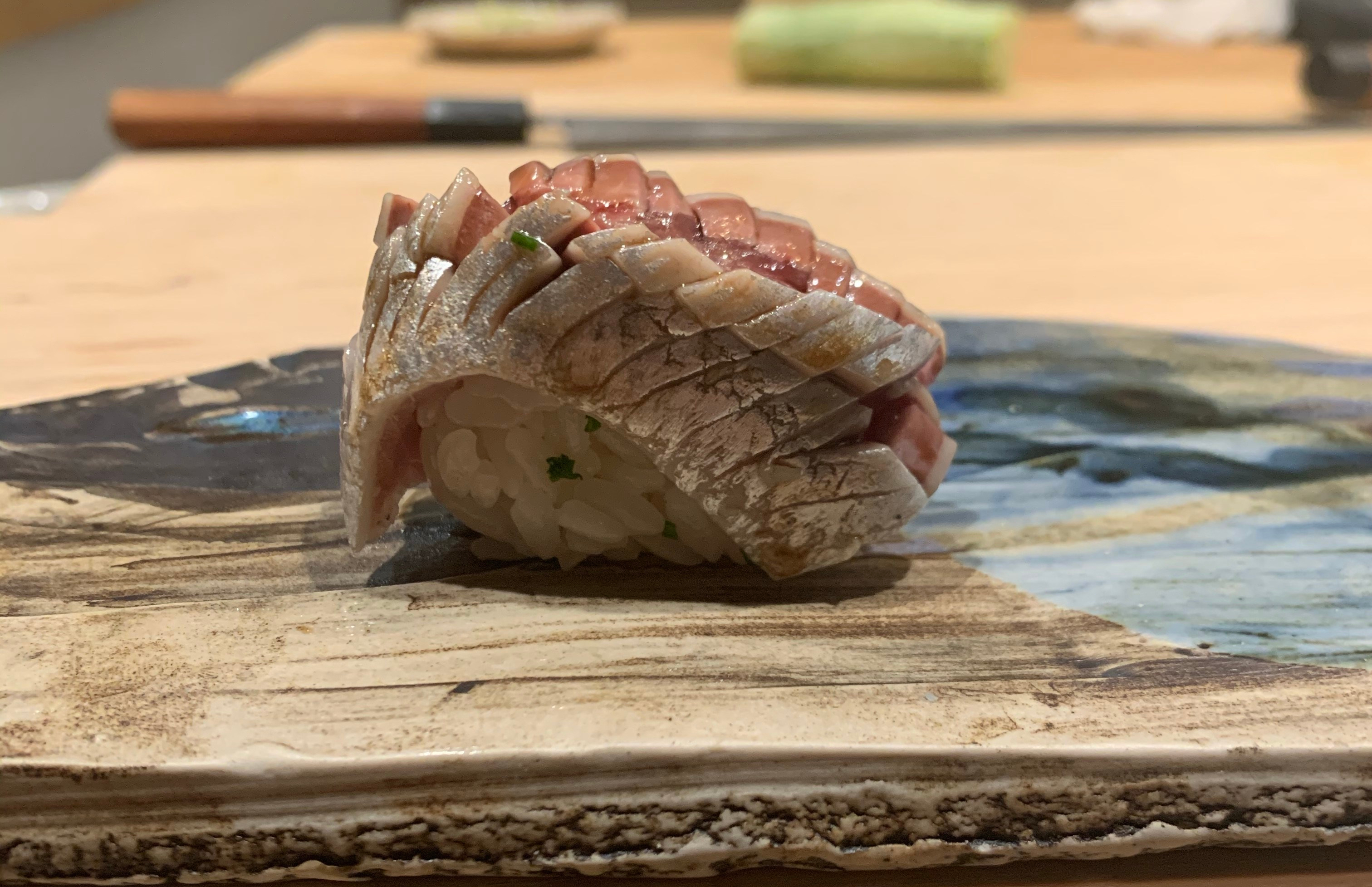 One piece of nigiri sushi with a flayed sardine filet on top