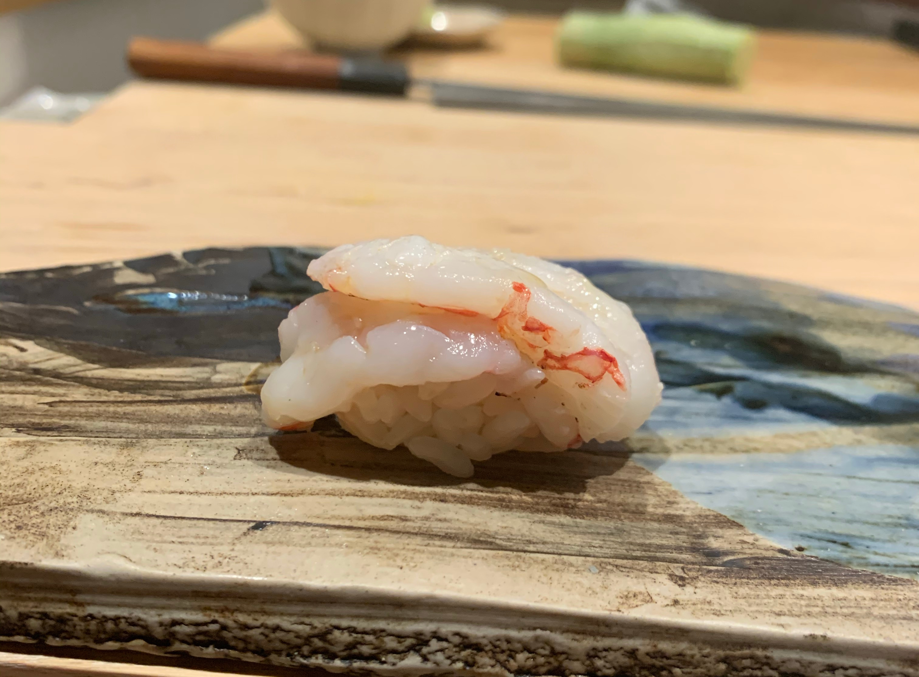 One piece of nigiri sushi with a very large shrimp on top