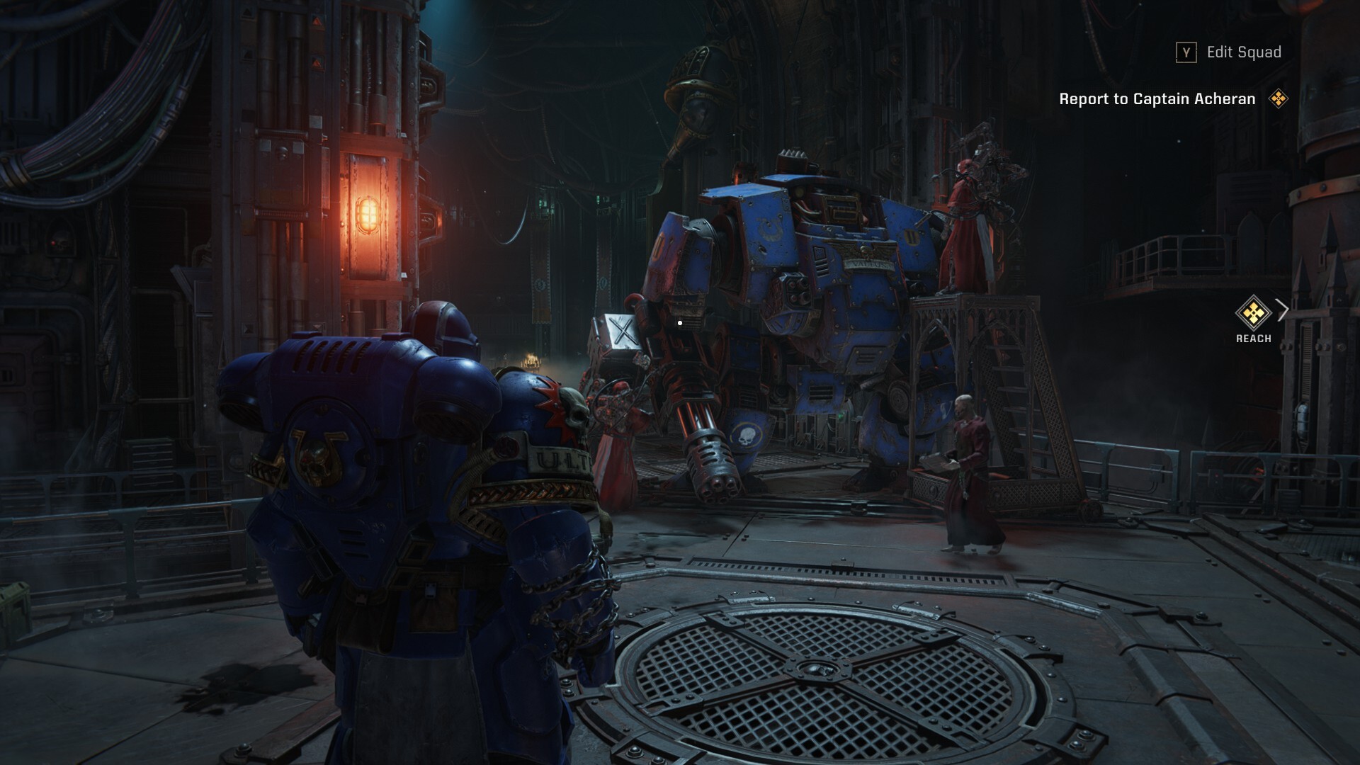 A large armoured man stands near an even-larger bipedal robot: a dreadnought. Several regular humans in red robes attend to the robot, requiring ladders to reach most of its components.