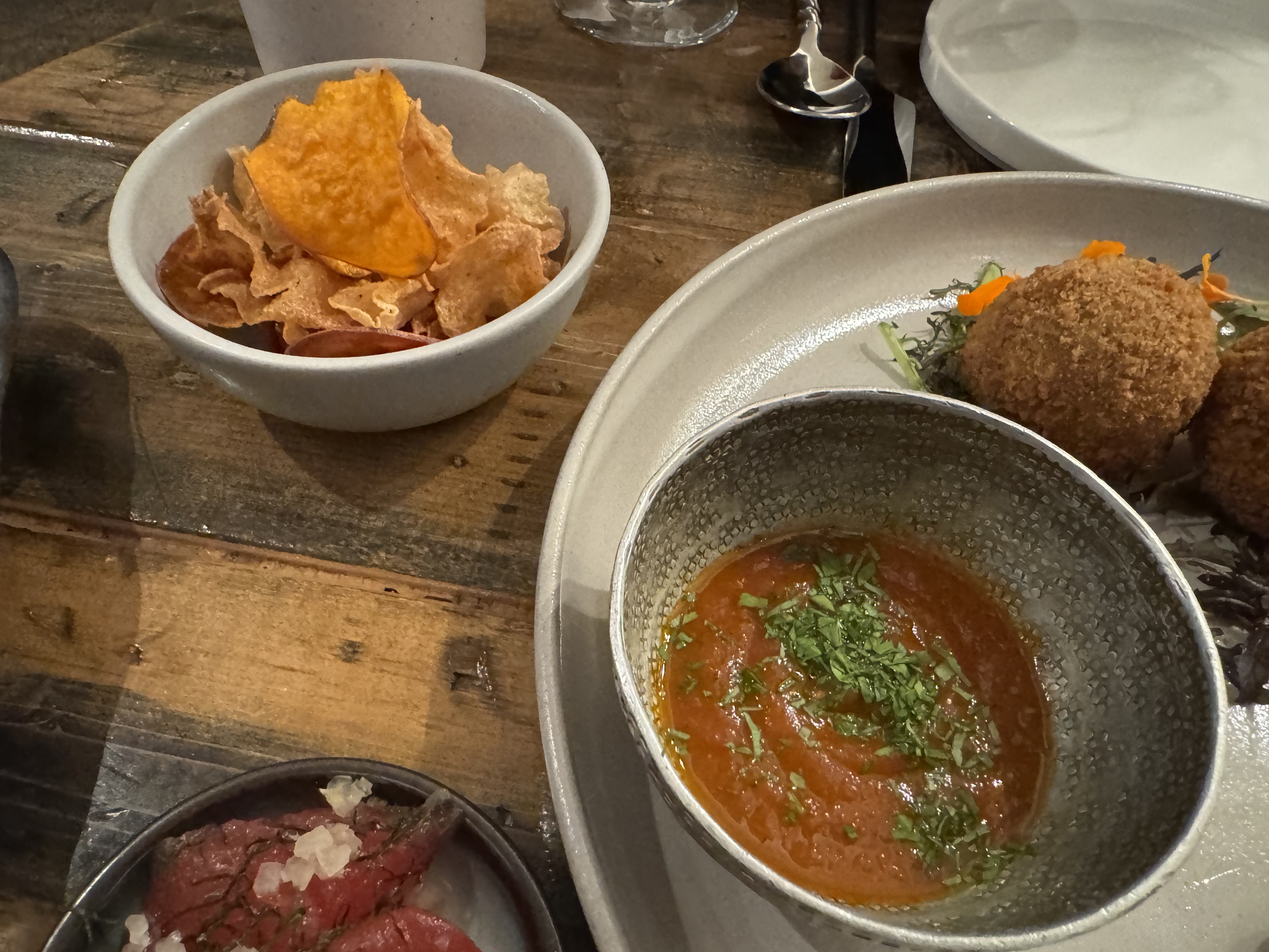 Bowl of thick, light-red tomato sauce. And a bowl of fried, very-thin jicama & sweet potato chips.