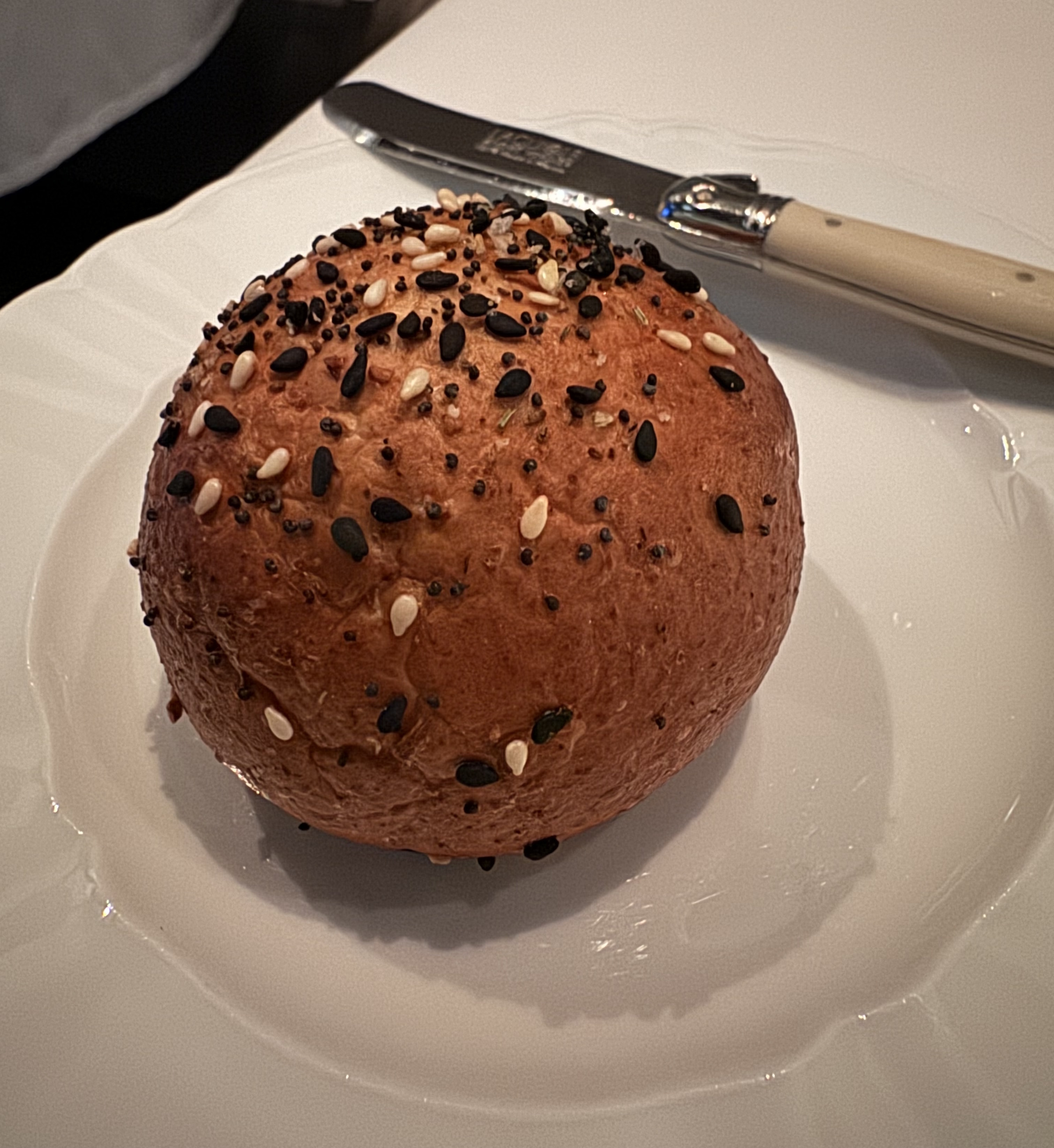 Perfectly round, seeded dinner roll