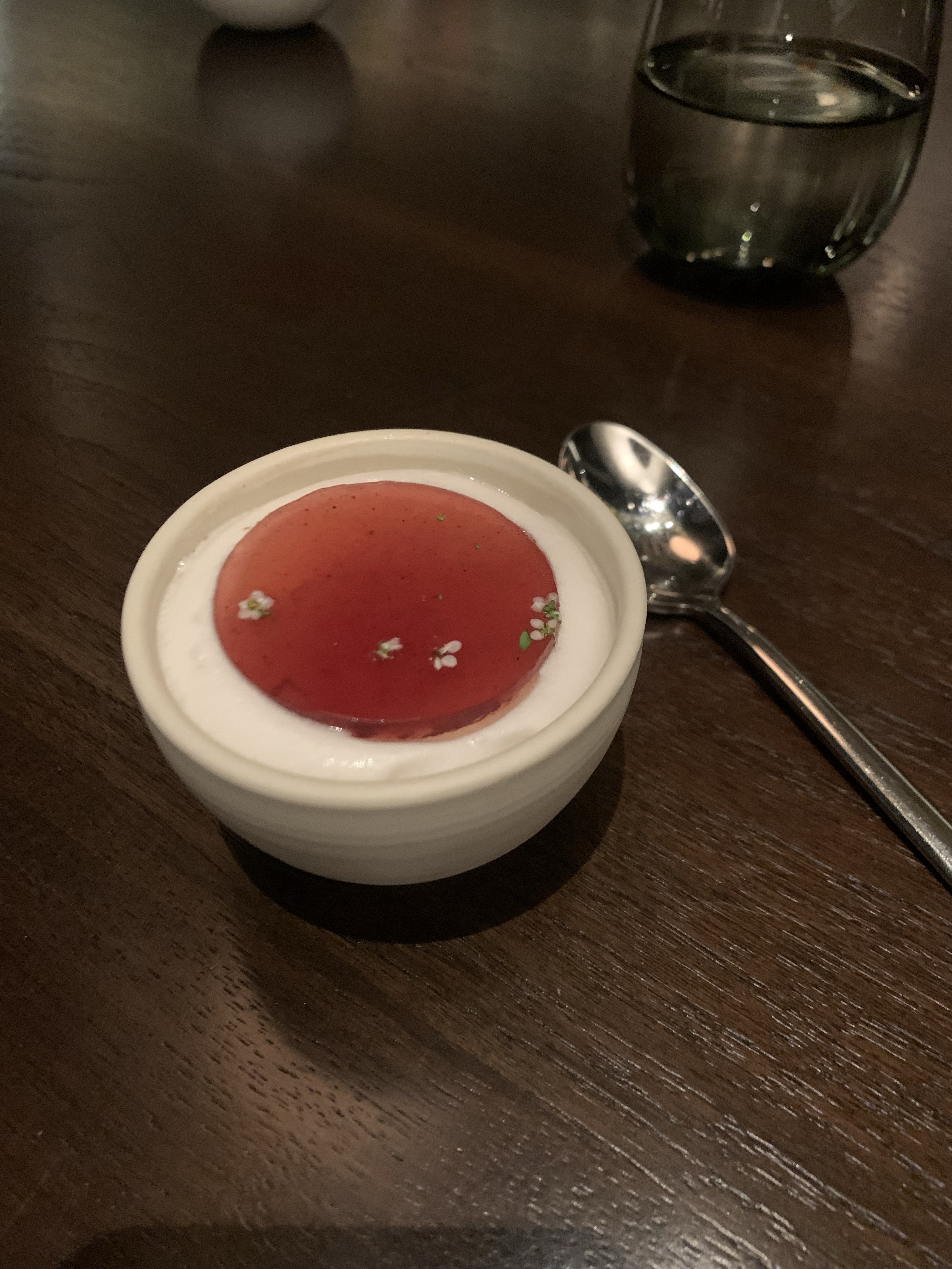 Disc of red jelly on top of white sorbet