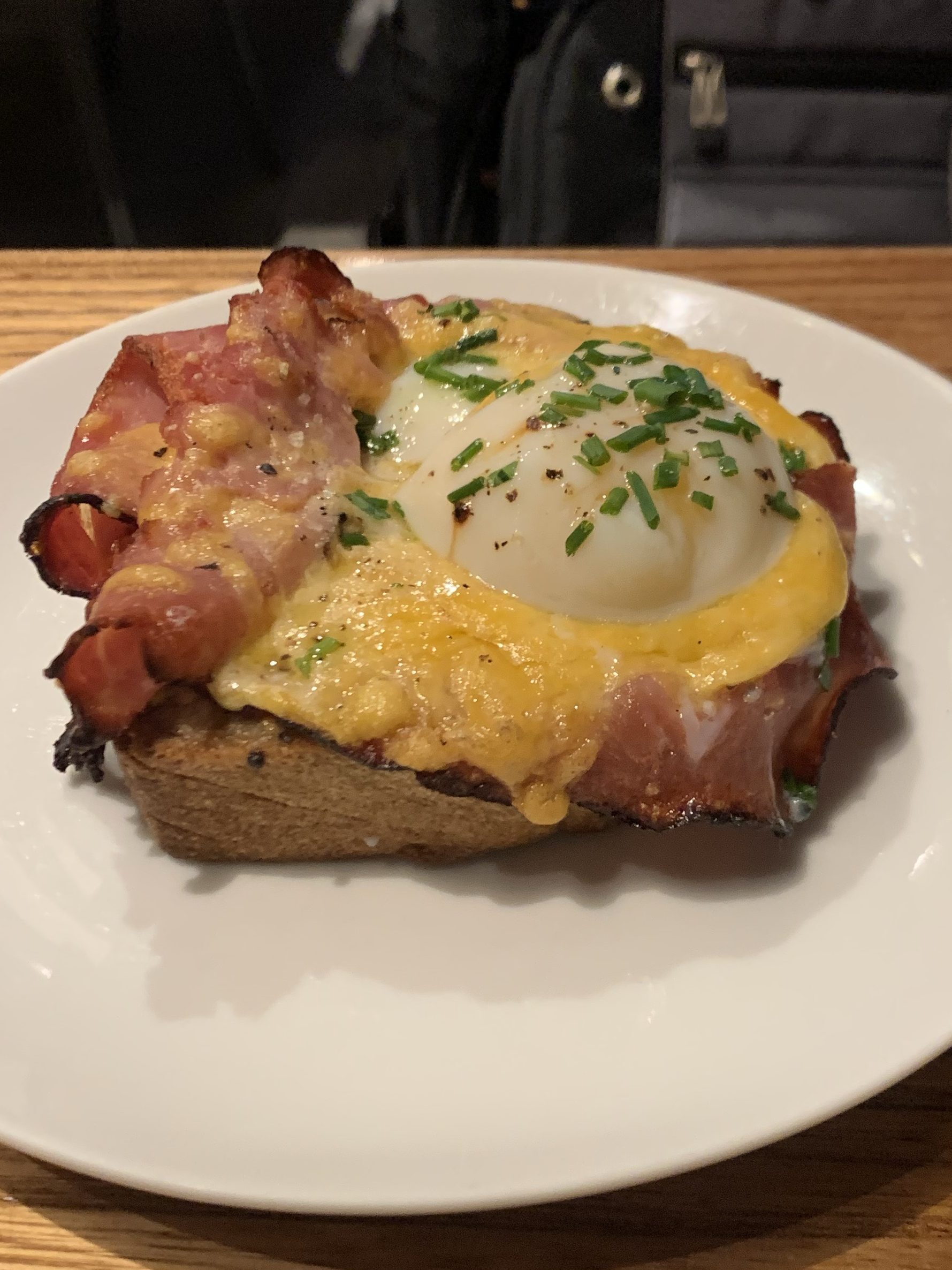 Egg held firm to bacon with a lot of cheese, on toast